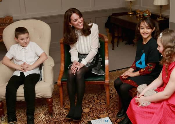 The Duchess of Cambridge, seen here chatting with children at Kensington Palace, has become guest editor of Huffington Post UK. Picture: PA