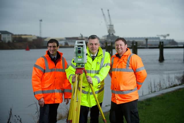 Mark Macmillan, leader of Renfrewshire Council (centre), joins Stuart Bloomfield (left) and Neil Cooper of Aird Geomatics on the banks of the Clyde at Renfrew, where a new road bridge will eventually be built