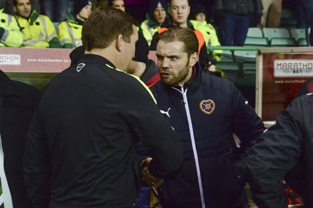 Robbie Neilson shakes hands with Alan Stubbs. The Hearts coach came off second best in the cup. Picture: SNS