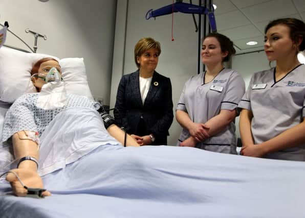 First Minister Nicola Sturgeon at the Alexander Fairley Clinical Skills Area with student nurses Peggy Smith and Alexandra McKinstry, far right, as they view a medical scenario using a mannequin at the Queen Elizabeth University Hospital in Glasgow. Picture: PA
