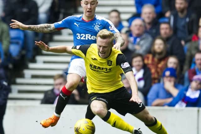 Barrie McKay (left) challenges for the ball with Livingston's Ross Millen. Picture: SNS