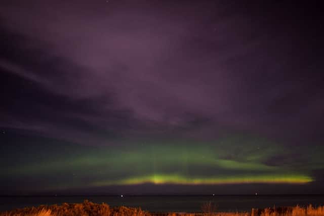 The  Northern Lights, are seen in the skies over the west beach in Lossiemouth. Picture: Hemedia
