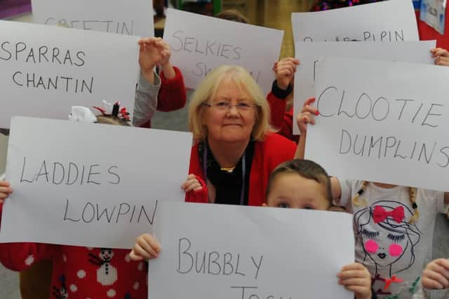 A selection of Scots terms are held up by pupils of Aileymill Primary School in Greenock. Image: Robert Perry