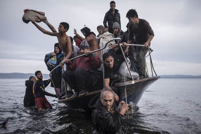 Sergey Ponomarev won 1st prize in the General News stories category with this photo showing refugees arriving by boat near the village of Skala on Lesbos. Picture: PA