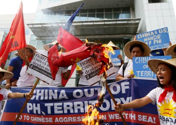 Filipino protesters in Makati City burn an effigy of a missile at the Chinese embassy. Picture: AP