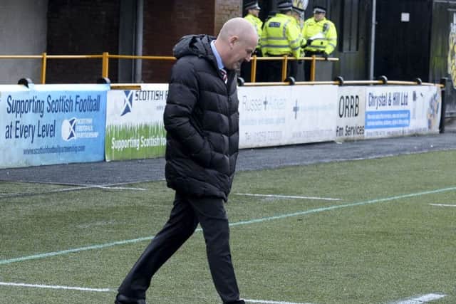 Mark Warburton inspects the turf prior to last weekend's draw with Alloa. Picture: SNS