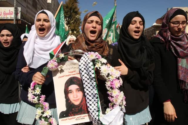 Friends and the twin sister of Kilzar Oweiwy, at the woman&#39s funeral. Picture: Getty