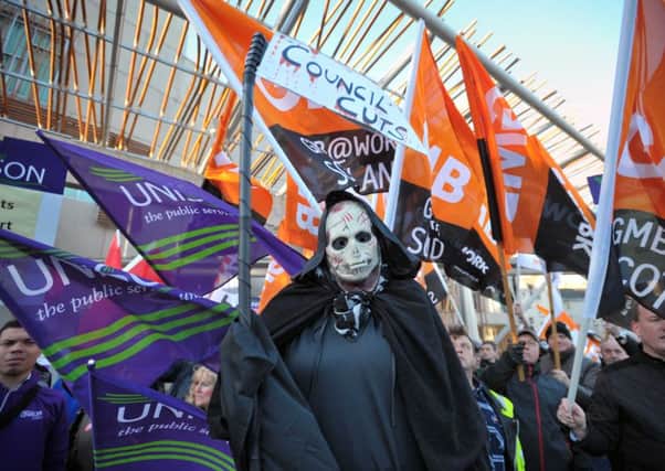 Protesters march over the cuts local  councils are having to impose in the wake of SNP budget cuts. Picture: Jane Barlow