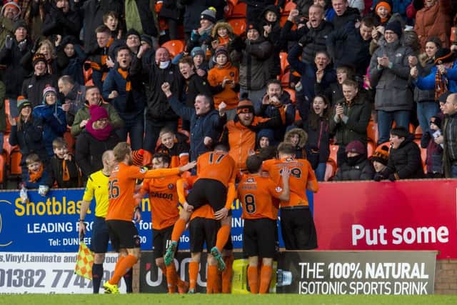 Dundee Utd players celebrate in front of their fans after Paul Paton's winning goal. Picture: SNS