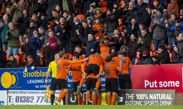 Dundee Utd players celebrate in front of their fans after Paul Paton's winning goal. Picture: SNS
