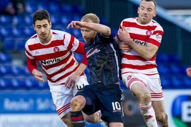 Ross County's Liam Boyce (centre) gets between Lucas Tagliapietra (left) and Darian MacKinnon. Picture: SNS