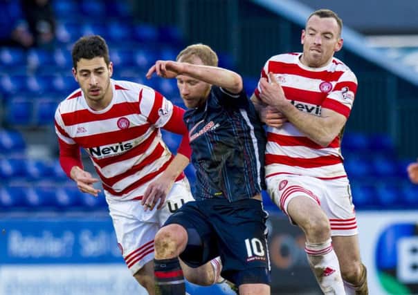 Ross County's Liam Boyce (centre) gets between Lucas Tagliapietra (left) and Darian MacKinnon. Picture: SNS