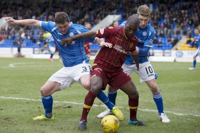 Motherwells Morgaro Gomis tries to shield the ball from St Johnstone goalscoring duo David Wotherspoon, right, and Tam Scobbie. Picture: SNS