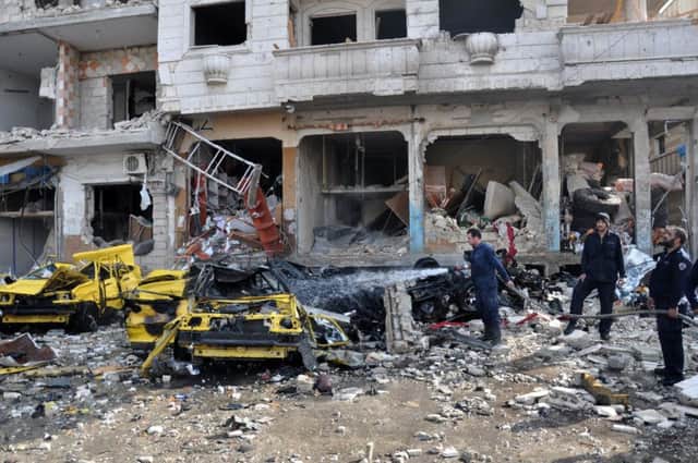 Two car bombs in the central city of Homs killed at least 57 people and wounded dozens more. Picture: AFP/Getty