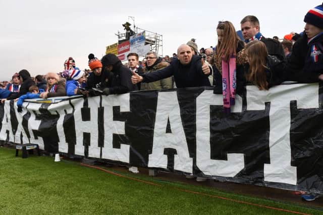 Fans display a banner at the game