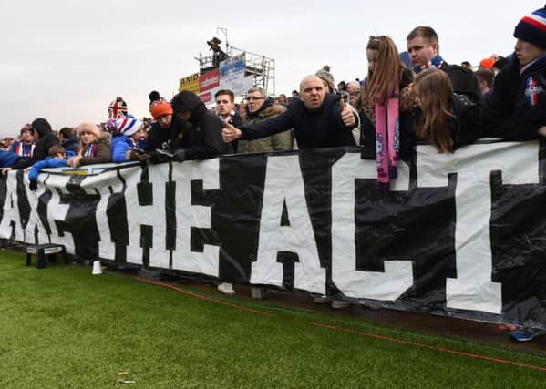 Fans display a banner at the game