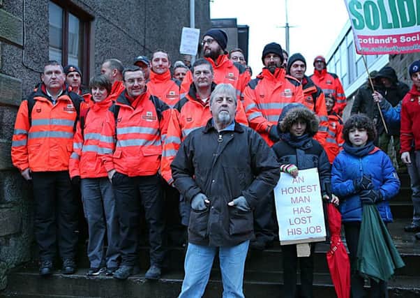 Dave Mitchell, who was sacked in 2014, with Royal Mail workers in Cupar. Picture: Dave Scott