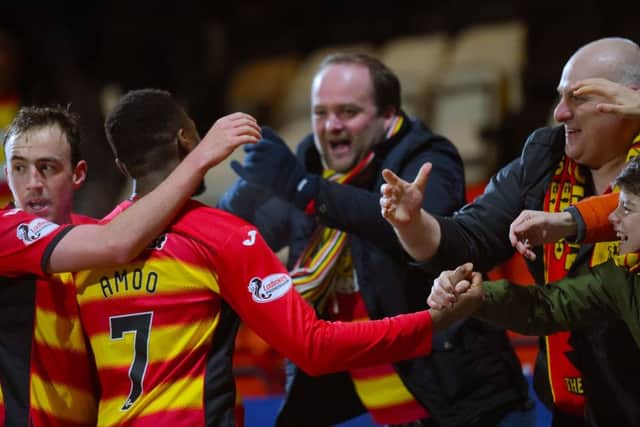 Partick's David Amoo (7) celebrates with fans after scoring his side's second. Picture: SNS