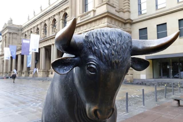 A bull statue stands in front of the Frankfurt market as its owner holds merger talks with the LSE. Picture: AP Photo/Michael Probst