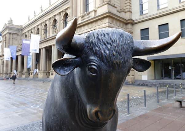 A bull statue stands in front of the Frankfurt market as its owner holds merger talks with the LSE. Picture: AP Photo/Michael Probst