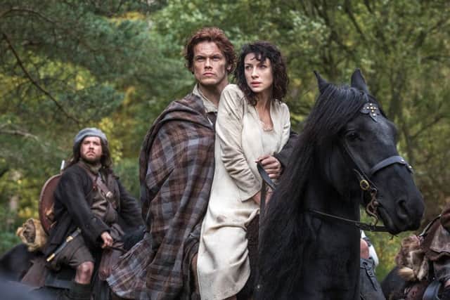 Caitriona Balfe as Claire Randall, right, and Sam Heughan as Jamie Fraser, in a scene from Starz' "Outlander." (AP Photo/Sony Pictures Television, Ed Miller)