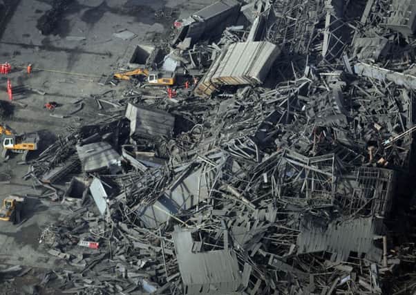 The collapsed building at Didcot power station is in a dangerous state, hampering efforts to find three missing men in the rubble. Picture: PA