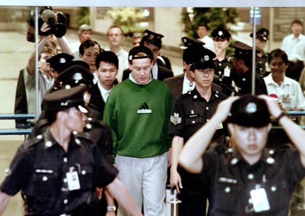 Barings Bank crashed after trader Nick Leeson, centre, lost more than £500 million in unauthorised dealing in 1995. Picture: AFP/Getty Images