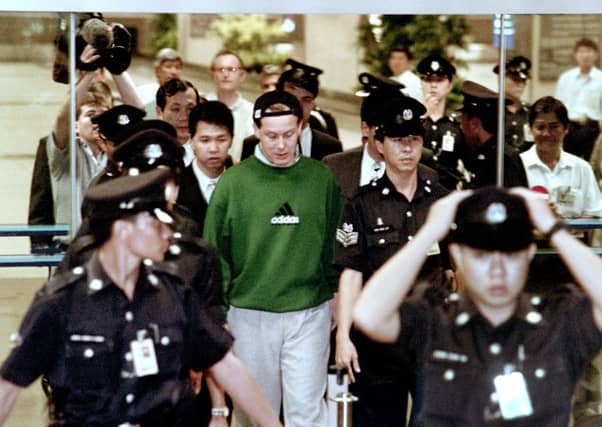 Barings Bank crashed after trader Nick Leeson, centre, lost more than £500 million in unauthorised dealing in 1995. Picture: AFP/Getty Images