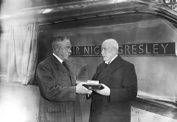 Sir Nigel Gresley, left, is presented with a silver model of the engine named after him by LNER chairman William Whitelaw in November 1937. Picture: Getty
