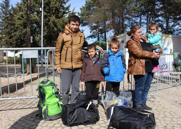 One of the refugee families in Serbia kitted out in clothes donated by people in Europe. Picture: Goran Stupar/World Vision