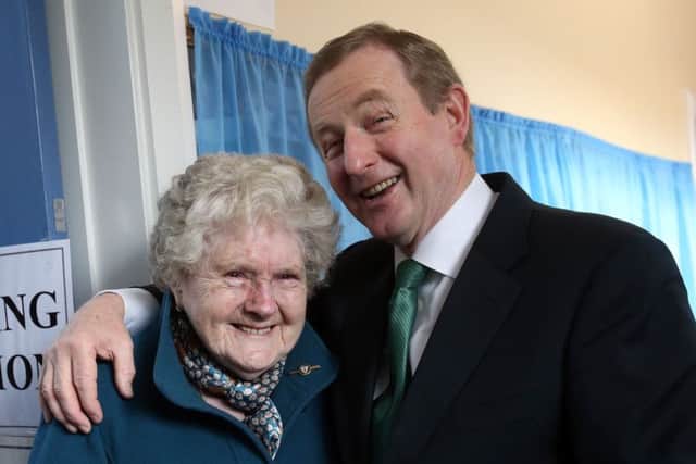 An Taoiseach Enda Kenny meets Bridie McLoughlin on her 88th birthday after they both cast their votes at a polling station at St Anthony's School in Castlebar Picture: Brian Lawless/PA Wire