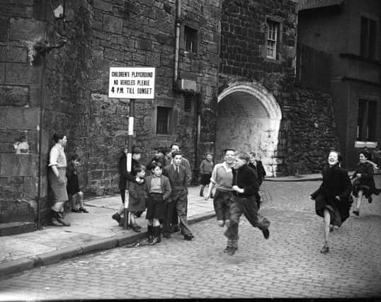 Children running on Johnston Street  in Leith. Picture: TSPL