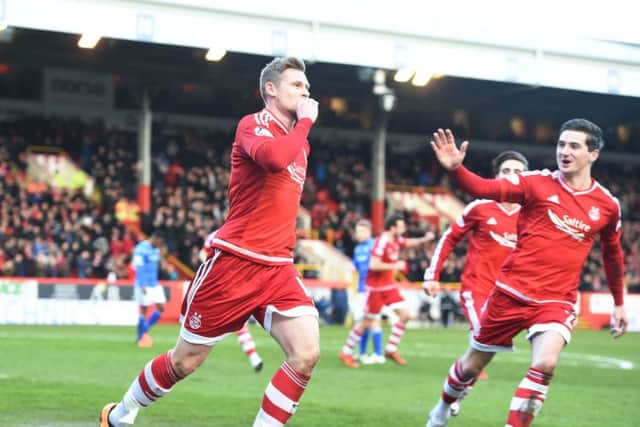 Aberdeen's Simon Church (left) celebrates opening the scoring with his team-mates. Picture: SNS