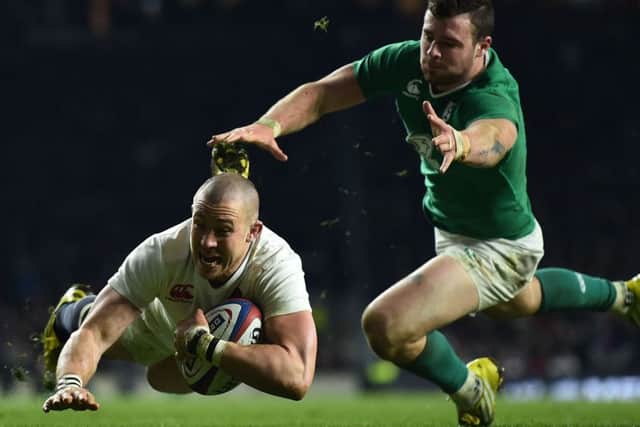 England's wing Mike Brown dives over to score a try against Ireland. Picture: Ben Stansall/AFP/Getty Images