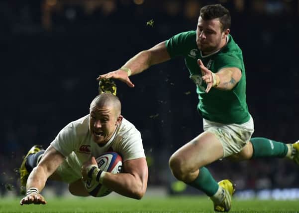 England's wing Mike Brown dives over to score a try against Ireland. Picture: Ben Stansall/AFP/Getty Images