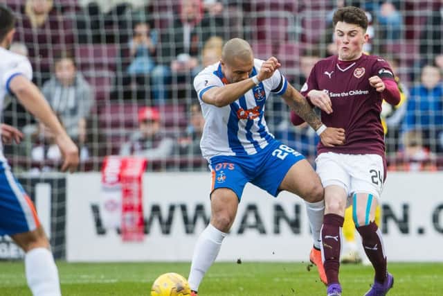 Hearts' John Souttar tackles Josh Magennis. Picture: ian Georgeson