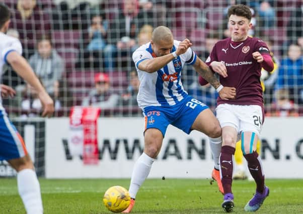 Hearts' John Souttar tackles Josh Magennis. Picture: ian Georgeson