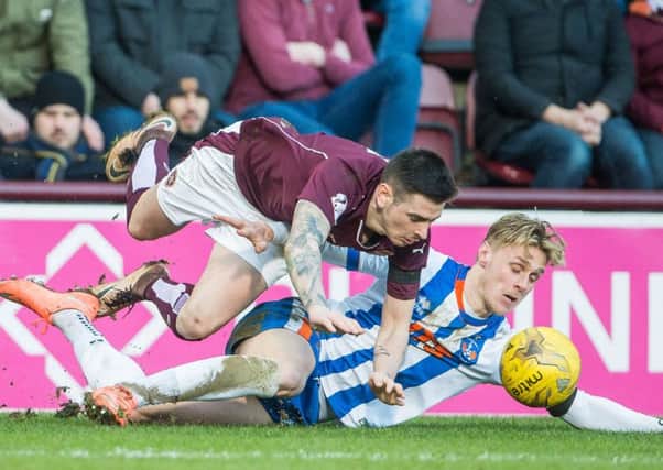 Hearts goalscorer Jamie Walker takes a tumble while challenged by Kilmarnocks Kevin McHattie at Tynecastle on Saturday. Picture: Ian Georgeson