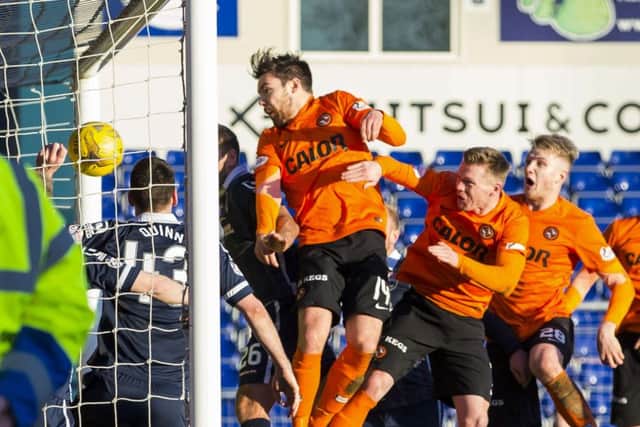 Ryan Dow (centre) heads home Dundee Uniteds third goal. Picture: SNS