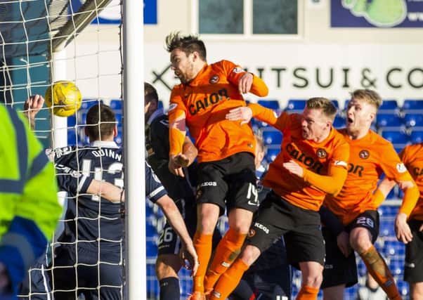 Ryan Dow (centre) heads home Dundee Uniteds third goal. Picture: SNS