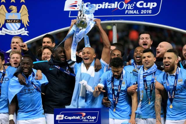 Manchester City captain Vincent Kompany lifts the Capital One Cup after his team beat Liverpool on penalties. Picture: PA
