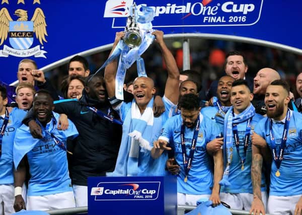 Manchester City captain Vincent Kompany lifts the Capital One Cup after his team beat Liverpool on penalties. Picture: PA