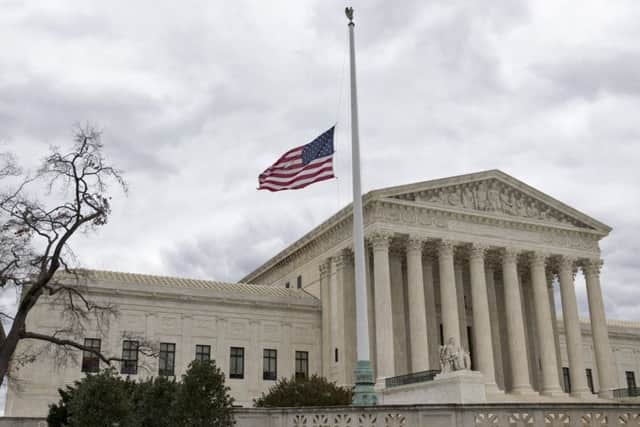 A flag in front of the Supreme Court in Washington flies at half mast in honour of Antonin Scalia. Picture: AP Photo/J Scott Applewhite