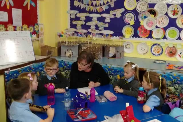 A volunteer from Clydesdale Bank works with pupils at St John's Primary, Barrhead, in November 2015. Picture: Contributed