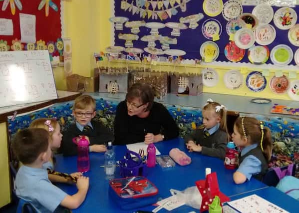 A volunteer from Clydesdale Bank works with pupils at St John's Primary, Barrhead, in November 2015. Picture: Contributed