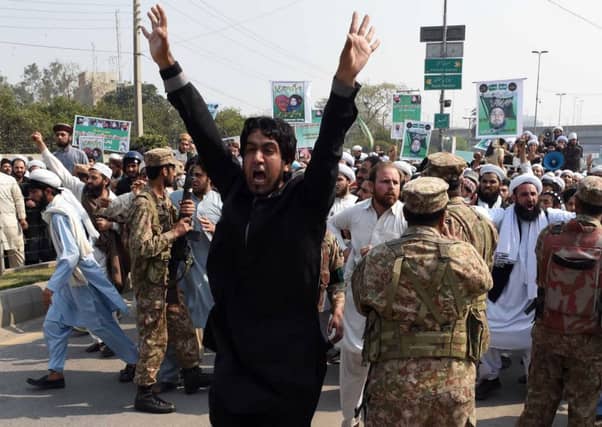 Pakistani soldiers try to stop the supporters of convicted murderer Mumtaz Qadri during a protest against Qadri's execution in Peshawar. Pic AFP
