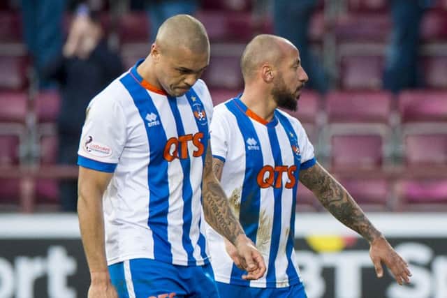 Magennis, left, claims he was targeted by a racist remark during Saturday's game. Picture: SNS