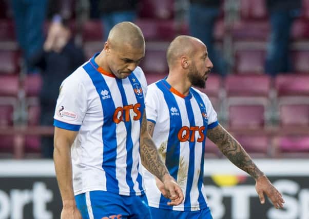Magennis, left, claims he was targeted by a racist remark during Saturday's game. Picture: SNS
