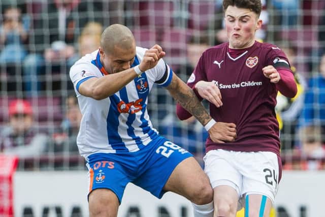 Josh Magennis, left, insists he was the victim of racial abuse in the match against Hearts. Picture: Ian Georgeson