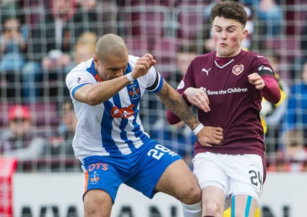 Josh Magennis, left, insists he was the victim of racial abuse in the match against Hearts. Picture: Ian Georgeson
